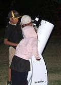 Pia students looking through a telescope