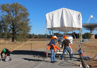 Preparing the PAF for sky tests at CSIRO's Parkes facilities (with the Parkes Radio Telescope in the background). Credit: John Sarkission, CSIRO.