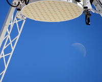A close up of a radio receiver with the moon in the background.