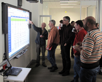 People looking at a SMART board in the Science Operations Centre.