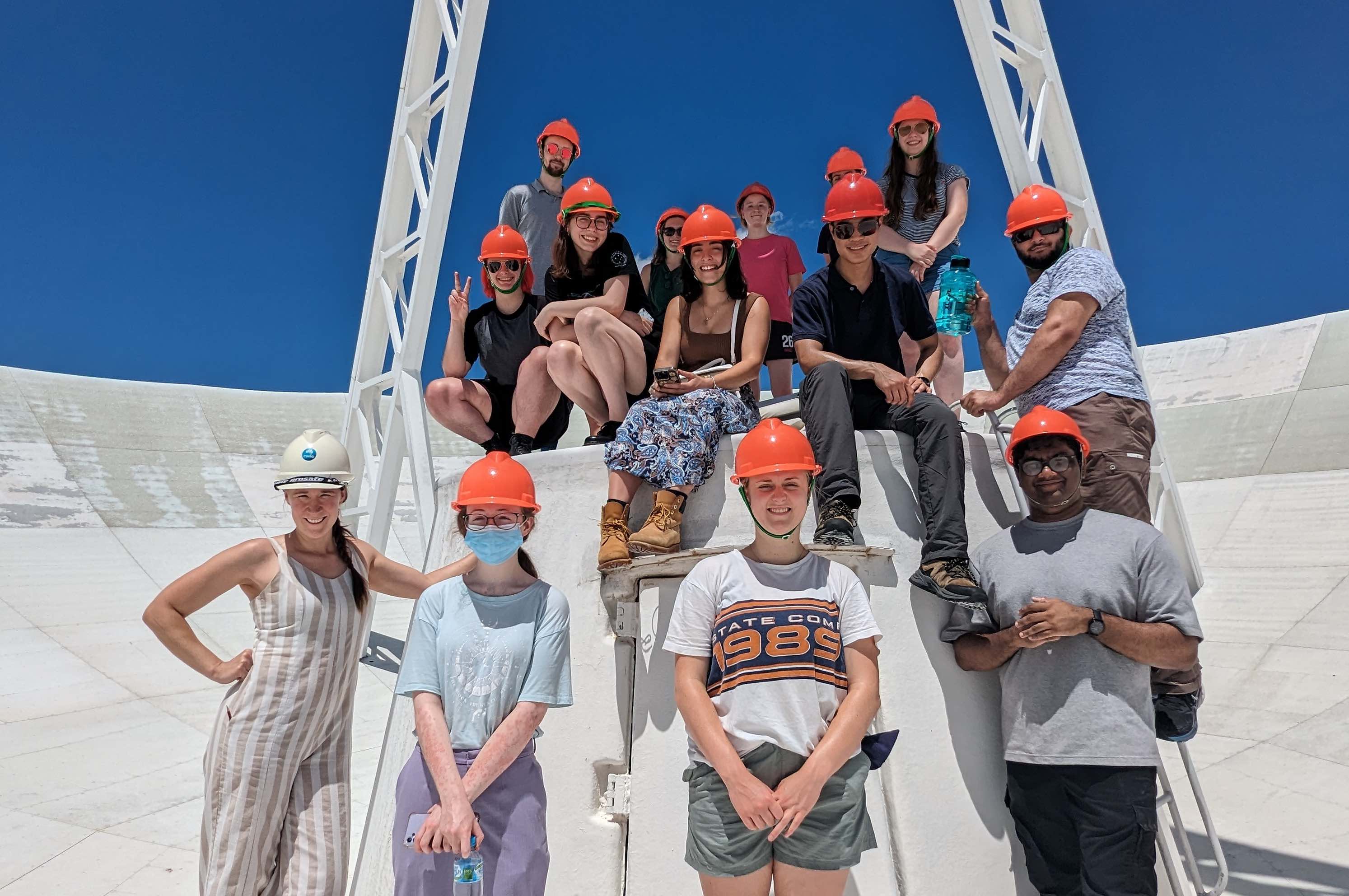 An image of the vacation students on the dish of an ATCA antenna, taken during their observing trip
