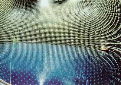 Inside Super-Kamiokande during the filling of the tank with 50,000 tons of pure water. Note the people in the raft next to a wall of photomultiplier tubes